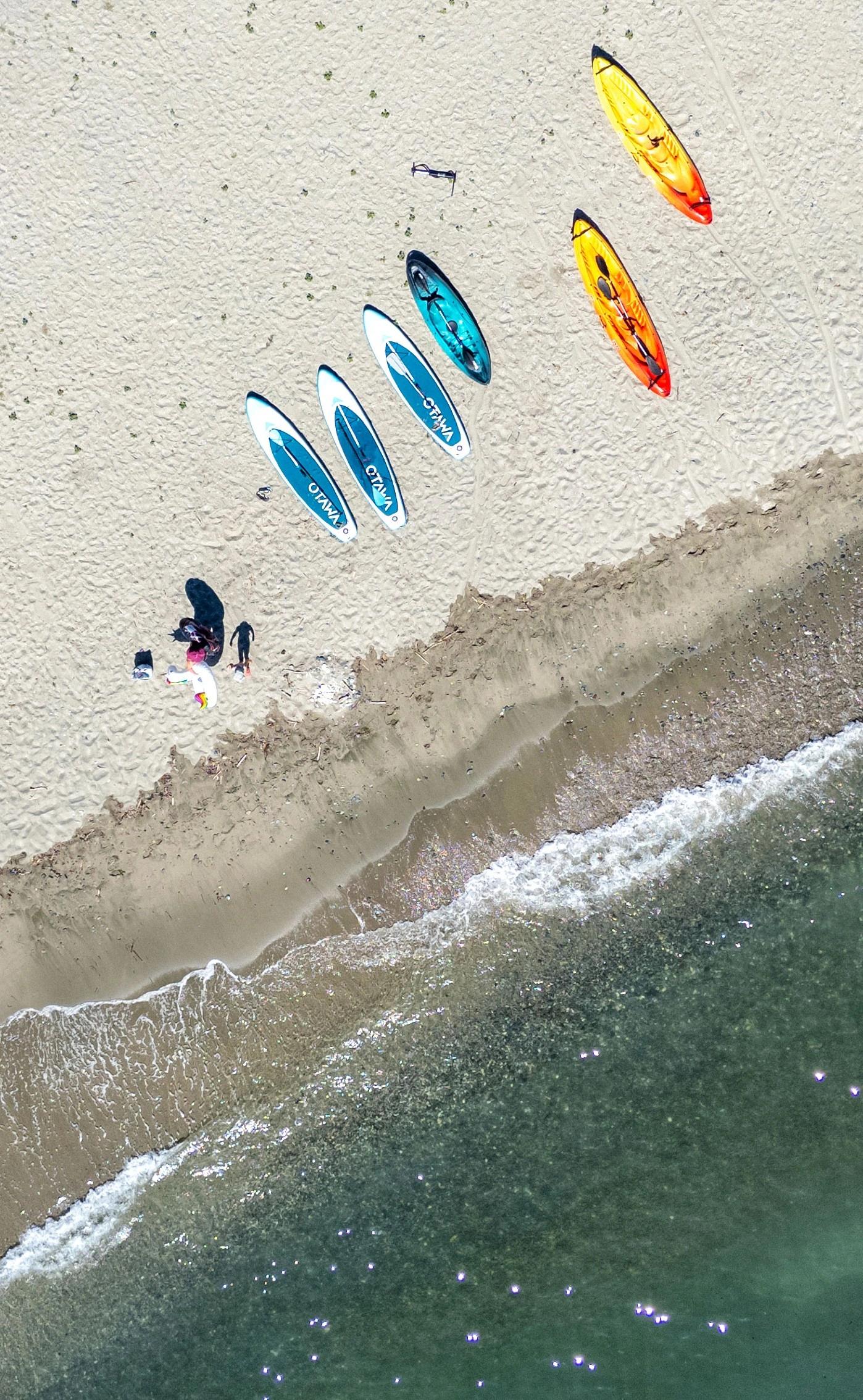 Vue aérienne de la plage de Moriani avec planches de paddle et activités nautiques près de l'hôtel San Lucianu 